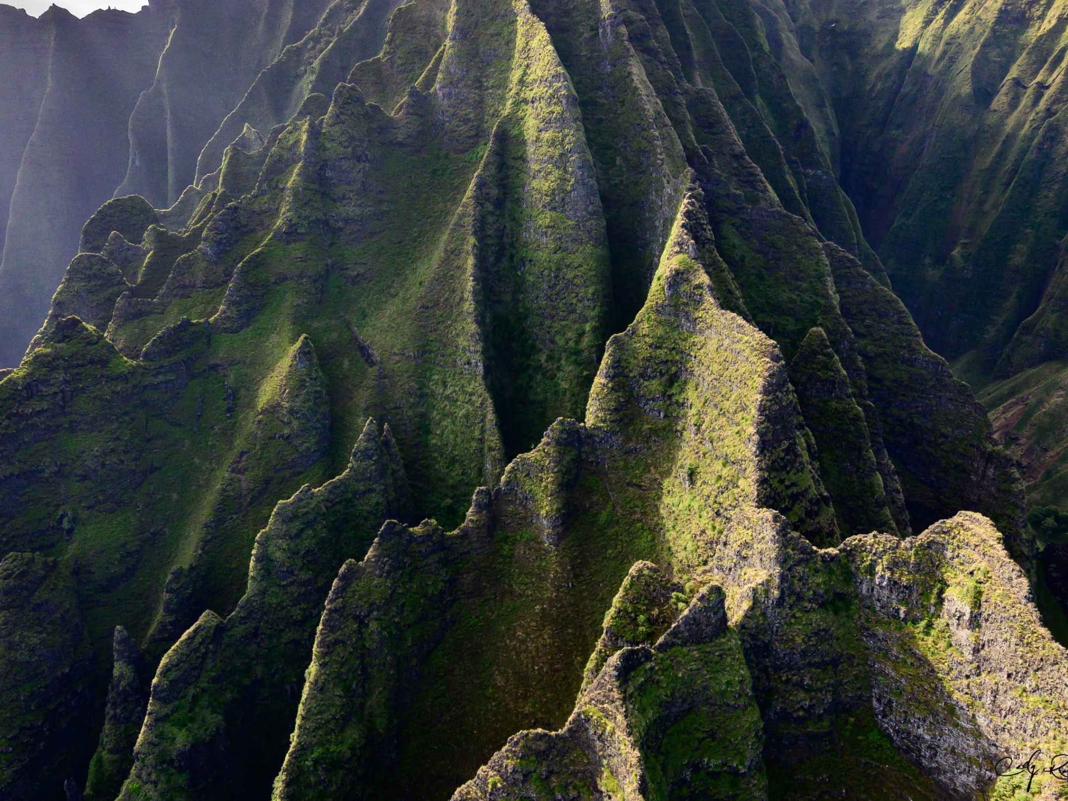 a waterfall with a mountain in the background