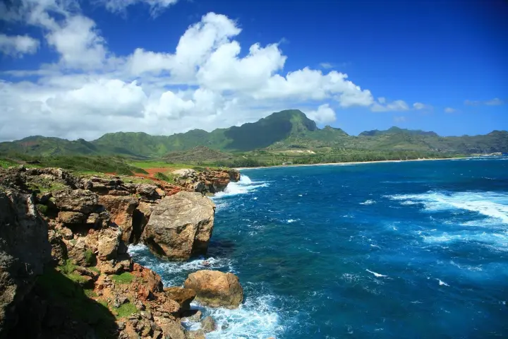 a large body of water with a mountain in the background