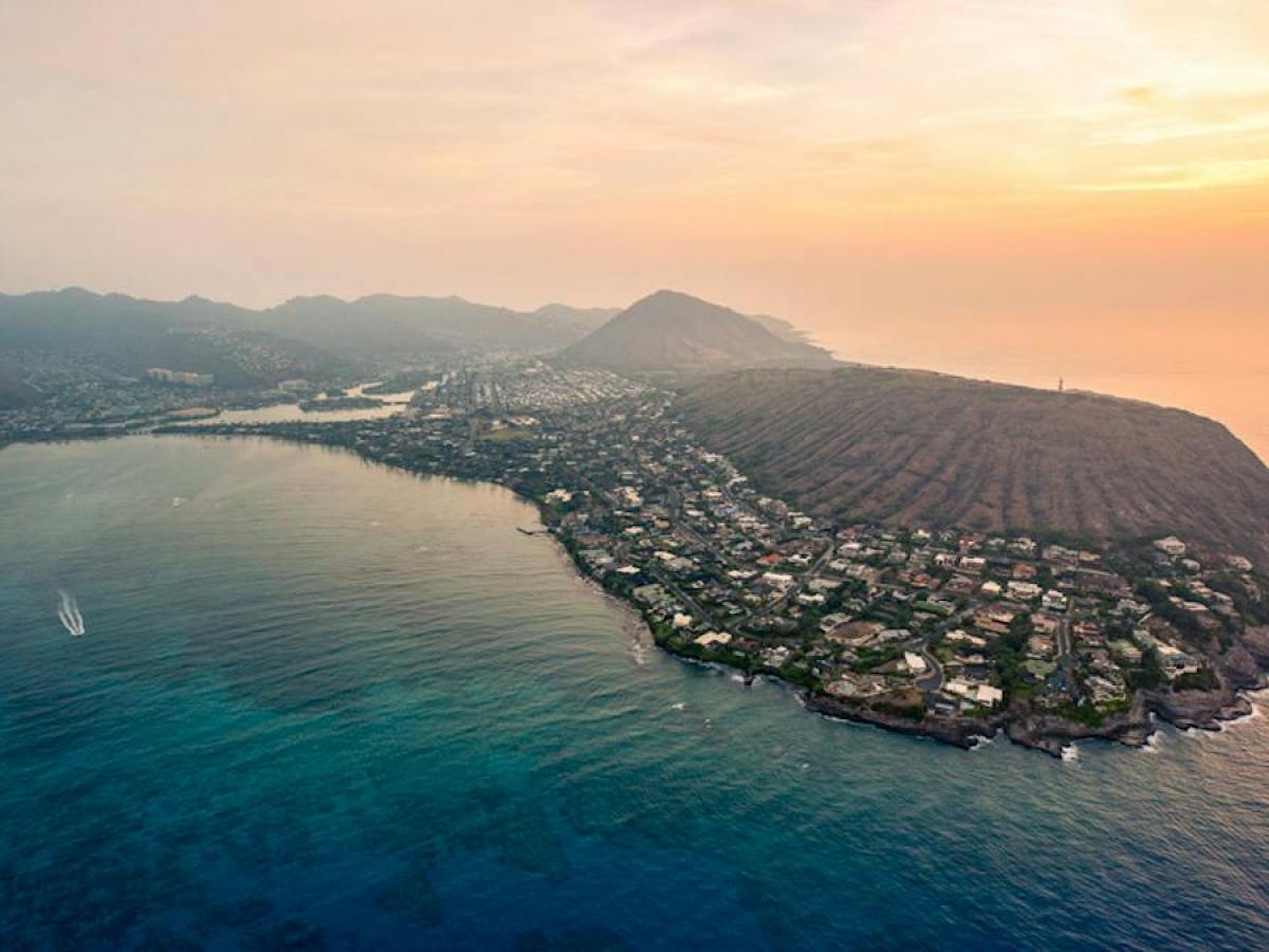 a large body of water with a mountain in the background