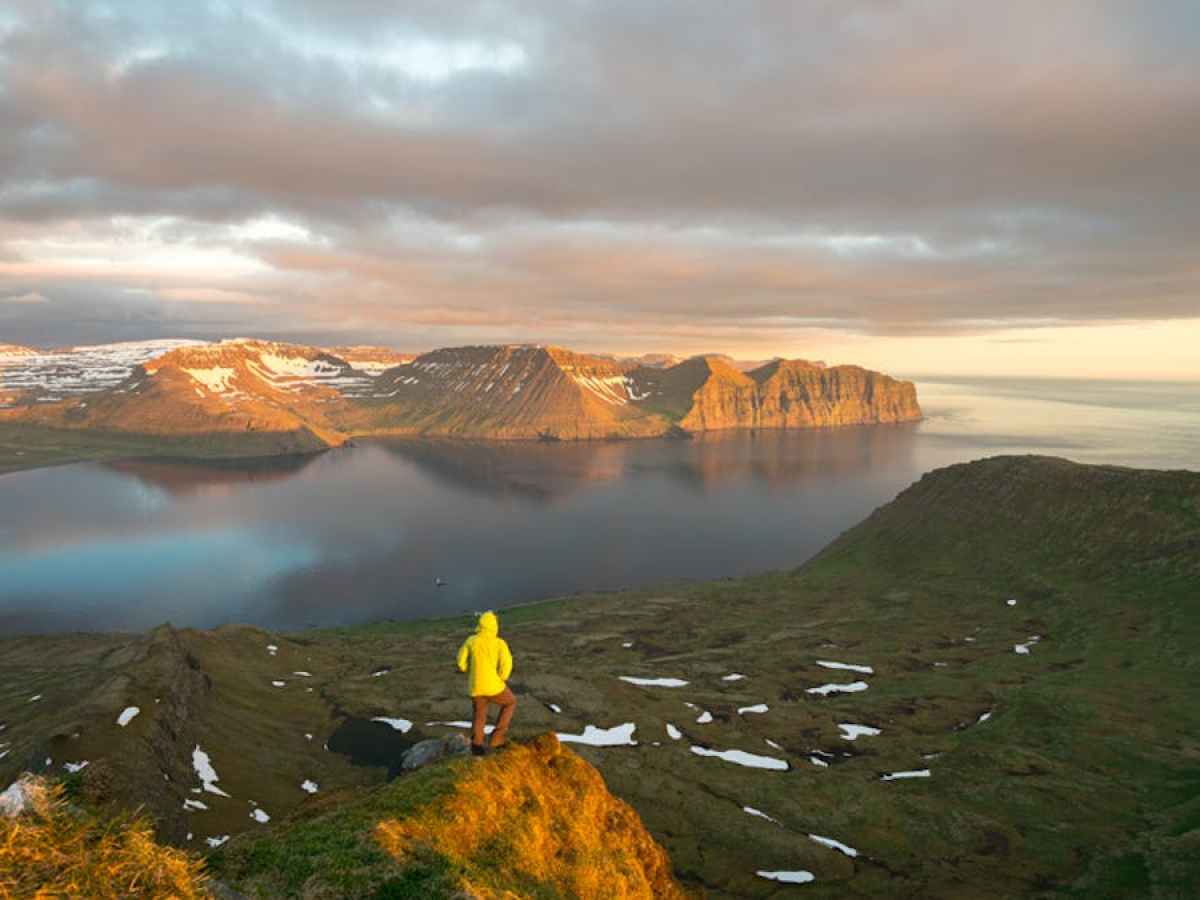 a body of water with a mountain in the background